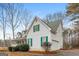 Side view of a two-story house showing the green shutters, green roof, two-car garage and well maintained landscape at 495 N Oakland Cir, Mcdonough, GA 30253