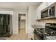 Well-equipped kitchen features stainless steel appliances, granite counters, and ample cabinet space with easy access to laundry at 495 N Oakland Cir, Mcdonough, GA 30253