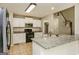 Modern kitchen with stainless steel appliances, granite countertops, and white cabinetry, offering style and functionality at 495 N Oakland Cir, Mcdonough, GA 30253