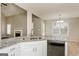 Kitchen island featuring a stainless steel double sink, granite countertop and stainless steel dishwasher with open view of living spaces at 495 N Oakland Cir, Mcdonough, GA 30253
