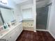 Bright bathroom with double sink vanity, garden tub, and glass-enclosed shower at 1630 Versailles Sw Dr, Atlanta, GA 30331