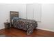 Cozy bedroom with hardwood floors, a twin bed, and natural light from the window at 1630 Versailles Sw Dr, Atlanta, GA 30331