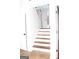 Inviting entryway showcasing a white door with transom window, wood stairs and tile flooring at 1630 Versailles Sw Dr, Atlanta, GA 30331