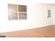 Bright living room with wood flooring, window and a white painted entry door at 1630 Versailles Sw Dr, Atlanta, GA 30331