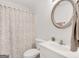 Stylish bathroom has a decorative mirror and a shower-tub combo at 220 Melrose Way, Mcdonough, GA 30252