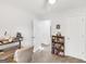 Neutral bedroom features a ceiling fan, an open door, and a bookshelf at 220 Melrose Way, Mcdonough, GA 30252