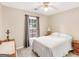 Bright bedroom with a ceiling fan and a window with backyard view at 220 Melrose Way, Mcdonough, GA 30252