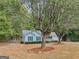 Quaint light blue home with manicured lawn and inviting front porch at 220 Melrose Way, Mcdonough, GA 30252