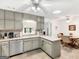 Well-lit kitchen featuring gray cabinets, modern appliances, and a bright breakfast nook at 220 Melrose Way, Mcdonough, GA 30252