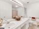 Well-lit main bathroom features double sink vanity and shower-tub combo at 220 Melrose Way, Mcdonough, GA 30252