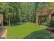 Large backyard with lush grass, mature trees, and a multi-level deck perfect for entertaining at 170 Majesty Ln, Fayetteville, GA 30215