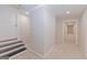 Finished basement area with carpet and partial brick wall leading to an open doorway at 170 Majesty Ln, Fayetteville, GA 30215