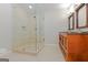 Modern bathroom with a glass-enclosed shower, stone flooring, and a stylish vanity with double sinks at 170 Majesty Ln, Fayetteville, GA 30215