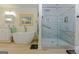 Bright bathroom with a soaking tub, glass-enclosed shower, and modern fixtures at 170 Majesty Ln, Fayetteville, GA 30215