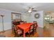 Open dining room featuring a traditional table set, wall decor, and hardwood flooring at 170 Majesty Ln, Fayetteville, GA 30215