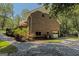 Brick home exterior with a side-entry garage and stone driveway in a wooded setting at 170 Majesty Ln, Fayetteville, GA 30215