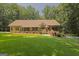 Charming brick home with a well-manicured lawn and mature trees at 170 Majesty Ln, Fayetteville, GA 30215