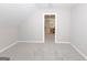 View from a bonus room into a hallway with new carpet and neutral paint at 170 Majesty Ln, Fayetteville, GA 30215