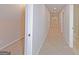 Long hallway with new carpet and bright neutral paint leads to bedrooms and bathrooms at 170 Majesty Ln, Fayetteville, GA 30215