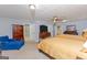 Open main bedroom featuring two beds, a ceiling fan, and a sitting area at 170 Majesty Ln, Fayetteville, GA 30215
