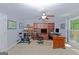 Dedicated office space featuring a built-in bookcase, a desk, and a ceiling fan at 170 Majesty Ln, Fayetteville, GA 30215