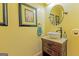 Stylish powder room with a vessel sink, framed art, and a decorative round mirror at 170 Majesty Ln, Fayetteville, GA 30215