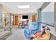 Basement lounge area with comfortable seating, TV, and a decorative window at 106 Robinson Bend Trl, Peachtree City, GA 30269