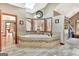 Bright bathroom featuring a soaking tub with tile surround and a large window at 106 Robinson Bend Trl, Peachtree City, GA 30269