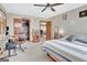 Bedroom with ceiling fan, gray walls, bed, wardrobe closet, and desk area at 106 Robinson Bend Trl, Peachtree City, GA 30269