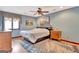 Bedroom features a window with curtains, ceiling fan, wood floors, and a leaf patterned rug at 106 Robinson Bend Trl, Peachtree City, GA 30269