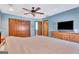 Bedroom with blue walls, natural wood trim, ceiling fan, and access to the en-suite at 106 Robinson Bend Trl, Peachtree City, GA 30269