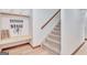 Hallway with storage bench, coat hooks, stairway with carpeted steps, and wood flooring at 106 Robinson Bend Trl, Peachtree City, GA 30269