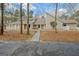 Spacious single story home with light siding, stone accents, and a walkway to the front door at 106 Robinson Bend Trl, Peachtree City, GA 30269