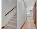 Hallway with stairway, hardwood floors, white walls, and view to white kitchen at 106 Robinson Bend Trl, Peachtree City, GA 30269