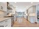 Spacious kitchen featuring stainless steel appliances, white cabinetry, and hardwood floors with view to dining room at 106 Robinson Bend Trl, Peachtree City, GA 30269
