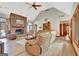 Bright living room with stone fireplace, ceiling fan, and an oversized leather sofa offering a cozy and relaxing atmosphere at 106 Robinson Bend Trl, Peachtree City, GA 30269