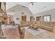 Cozy living room with vaulted ceilings, fireplace, and large leather sectional, perfect for Gathering gatherings at 106 Robinson Bend Trl, Peachtree City, GA 30269