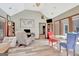 Living room with wood floors, a ceiling fan, and large windows looking out to the backyard at 106 Robinson Bend Trl, Peachtree City, GA 30269