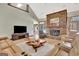 Open living area featuring a stone fireplace, large leather sectional, and a clear view to the outdoor pool and patio at 106 Robinson Bend Trl, Peachtree City, GA 30269