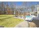 Backyard pool with patio and lounge chairs surrounded by a lawn and treeline at 106 Robinson Bend Trl, Peachtree City, GA 30269