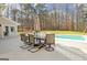 Backyard pool with hot tub and stone fireplace with built-in grill and patio seating at 106 Robinson Bend Trl, Peachtree City, GA 30269