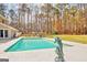 Backyard pool view showcasing lush greenery, lounge seating, and mature trees at 106 Robinson Bend Trl, Peachtree City, GA 30269