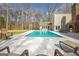 Backyard pool with hot tub and stone fireplace with built-in grill and entertaining space at 106 Robinson Bend Trl, Peachtree City, GA 30269