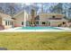 Backyard pool with a stone fireplace and outdoor seating area at 106 Robinson Bend Trl, Peachtree City, GA 30269