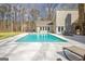Backyard pool with hot tub and stone fireplace with built-in grill and entertaining space at 106 Robinson Bend Trl, Peachtree City, GA 30269