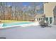 Backyard pool with hot tub and stone fireplace with built-in grill and entertaining space at 106 Robinson Bend Trl, Peachtree City, GA 30269