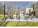 Backyard pool with lounge seating, a grassy yard, and treeline behind the home at 106 Robinson Bend Trl, Peachtree City, GA 30269