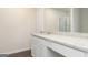 Bathroom with a large vanity with stone countertop, white cabinets, and a framed mirror at 1048 Claas Way, Locust Grove, GA 30248