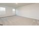 Bedroom showcasing neutral walls, plush carpet, and two bright windows at 1048 Claas Way, Locust Grove, GA 30248