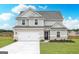 Charming two-story home featuring a brick-accented facade, a two-car garage, and a well-maintained lawn at 1048 Claas Way, Locust Grove, GA 30248